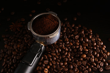 Holder with ground coffee and coffee beans