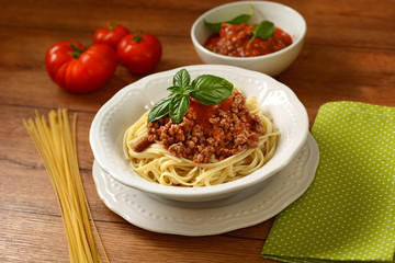 Spaghetti with meat sauce with ingredients around