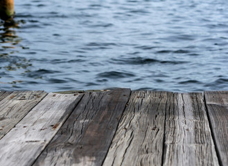 textured background - old wooden dock over blue water