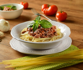 Spaghetti with meat sauce with ingredients around
