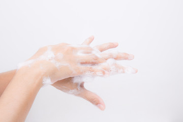 Naklejka premium Asian girl's hands are washing with soap bubbles.on white background