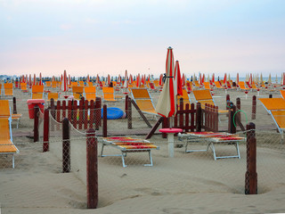 Comfortable beach with sun beds and orange umbrellas