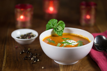 Tomato Soup Served in a Bowl with Basil and Sour Cream Garnish