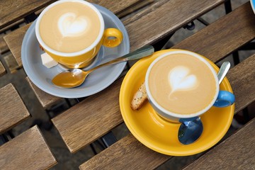 Two cups of delicious cappuccino on a summer day