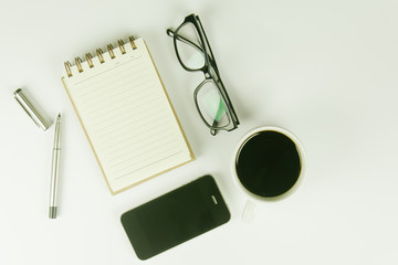 White office desk table with a lot of things on it. Top view with copy space.