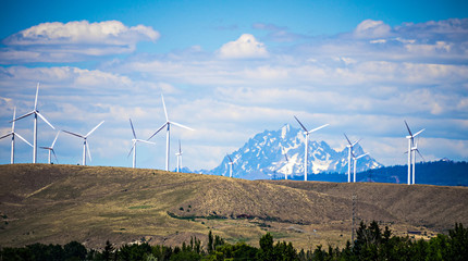 wind turbine farm with wenatchee mountains in the background