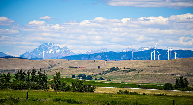 wind turbine farm with wenatchee mountains in the background