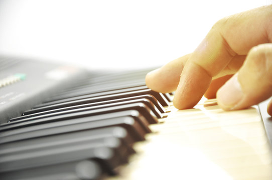 soft focus musician hands playing piano on piano keyboard.low key tone image.concept for live music festival.Instrument on stage,classical music.abstract musical background.