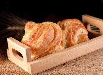 Tasty croissants on wooden background.