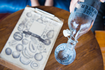 pouring pure water from bottle into glass