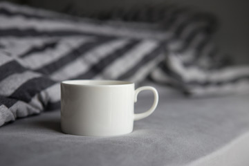 morning coffee cup on bed