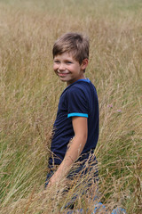 Handsome boy in summer meadow