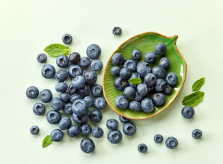 blueberries on green paper background