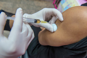 soft focus,nurses are vaccinations to patients using the syringe.Doctor vaccinating women in...