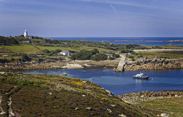 View across to St Agnes from Gugh, with a distant Bishop Rock Lighthouse, Isles of Scilly, Cornwall, England, UK.