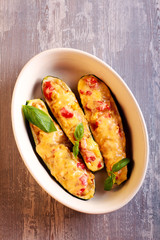 Stuffed zucchini with vegetables and melted cheese