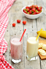 Strawberry and banana milkshake smoothie in the glass with straw