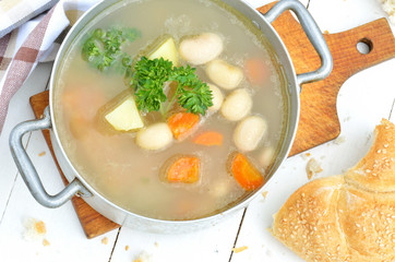 Bean soup in an old mess tin, bun and towel