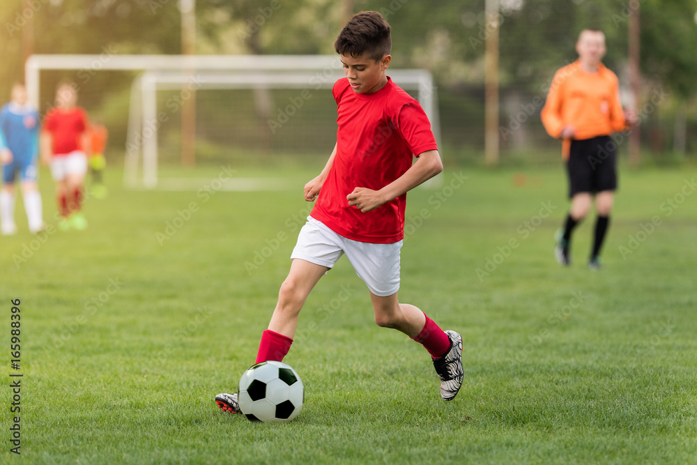 Wall mural Kids soccer football - children players match on soccer field