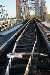 white electric guitar on the railroad tracks and stones