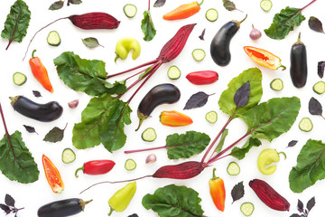 Fresh vegetables on a white background. Beetroot with green tops, eggplant, pepper. Pattern of vegetables. Healthy food concept. Top view, flat lay.