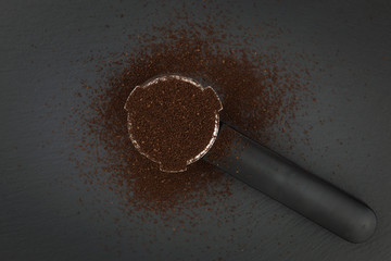 Fototapeta na wymiar Espresso filter holder for coffee machine on Black background with copy space