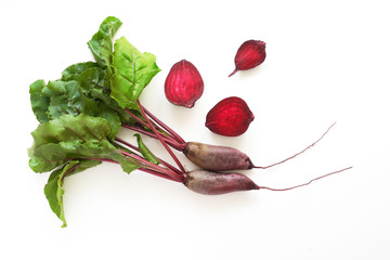 Composition of fresh beets with tops and beets in a cut isolated on a white background. Healthy...