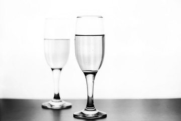 monochrome photo of champagne on white table on white background isolate