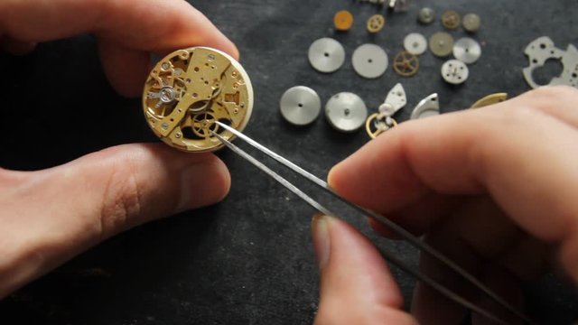 Watchmaker is repearing a mechanical watches