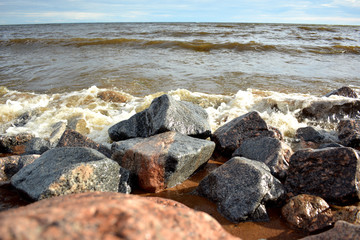 Stony shore and waves of the sea