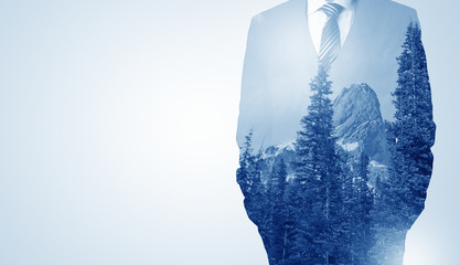 Businessman standing with mountain