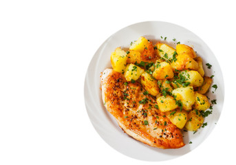 Grilled chicken breast with potato in a plate. top view. isolated on white