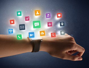 Female hand wearing smartwatch with app icons