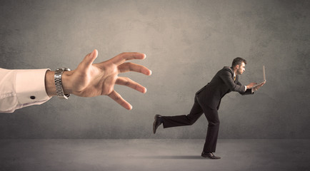 Businessman running from hand