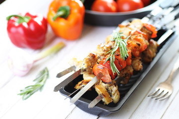 Kebab cooked on metal skewers with vegetables