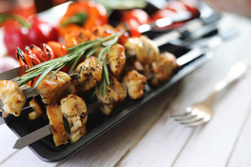Kebab cooked on metal skewers with vegetables