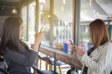 Asian women take photos to a friend