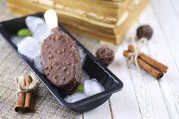 Dessert chocolate ice cream with nuts on wooden stick
