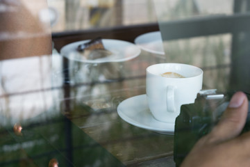 Photos from outside coffee shop focus on coffee cup