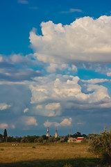 Summer landscape with a church and bell tower