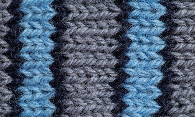 A beautiful closeup of a hand knitted warm and soft wool pattern. Soft socks or scarf of natural wool. Colorful pattern.