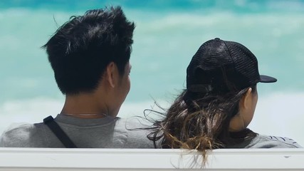 Multiethnic couple admiring beautiful view, relaxing and sunbathing on beach