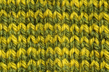 A beautiful closeup of a hand knitted warm and soft wool pattern. Soft socks or scarf of natural wool. Colorful pattern.