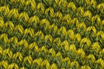 A beautiful closeup of a hand knitted warm and soft wool pattern. Soft socks or scarf of natural wool. Colorful pattern.