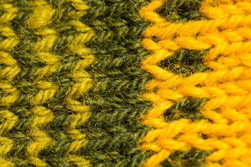 A beautiful closeup of a hand knitted warm and soft wool pattern. Soft socks or scarf of natural wool. Colorful pattern.
