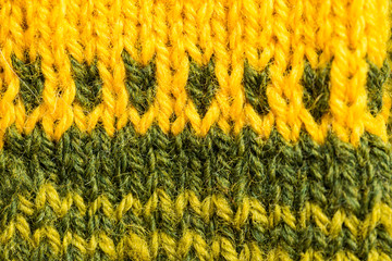 A beautiful closeup of a hand knitted warm and soft wool pattern. Soft socks or scarf of natural wool. Colorful pattern.