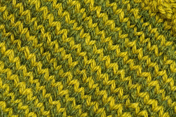 A beautiful closeup of a hand knitted warm and soft wool pattern. Soft socks or scarf of natural wool. Colorful pattern.