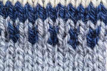 Fototapeta premium A beautiful closeup of a hand knitted warm and soft wool pattern. Soft socks or scarf of natural wool. Colorful pattern.