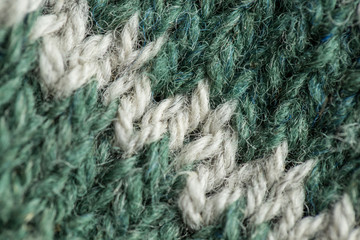 A beautiful closeup of a hand knitted warm and soft wool pattern. Soft socks or scarf of natural wool. Colorful pattern.