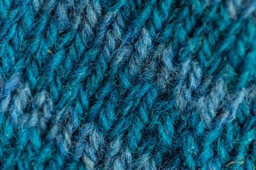 A beautiful closeup of a hand knitted warm and soft wool pattern. Soft socks or scarf of natural wool. Colorful pattern.